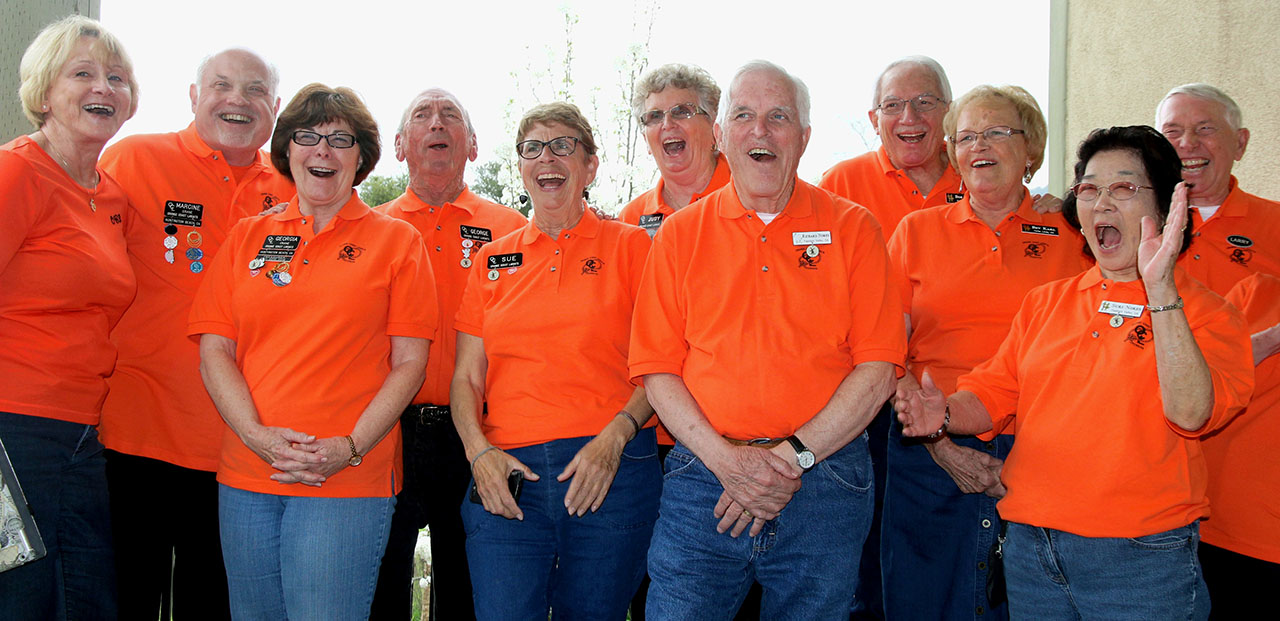Orange Coast Lariats members together in their orange club shirts