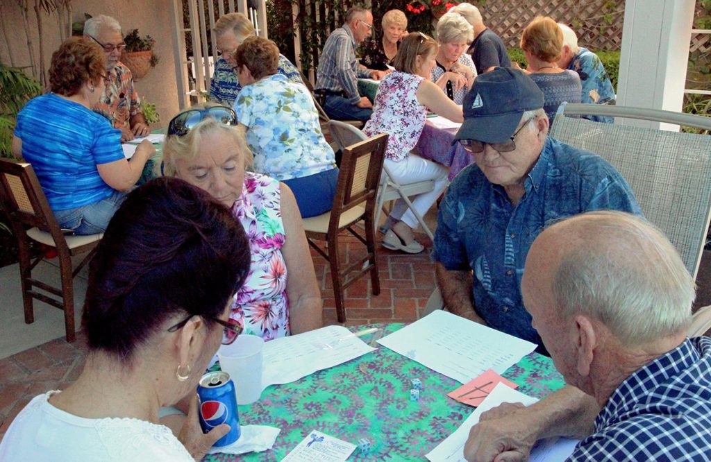 Club friends gathered around tables playing games together